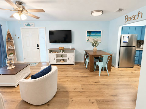 Living and dining open to the blue kitchen