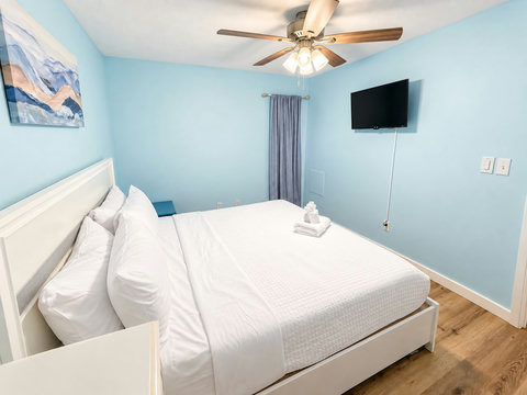 Serene primary bedroom with wall-mounted TV