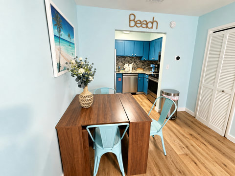 Dining nook with blue chairs by the kitchen