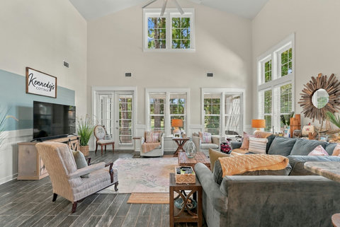 Vaulted living room with sectional sofa and TV