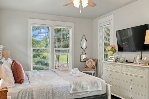 Primary bedroom with TV and dresser