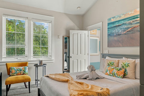 Bunk room queen bed with beach art