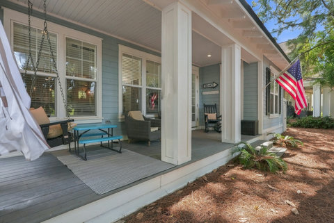 Side porch with swing and kids' picnic table