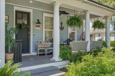 Front porch with ceiling fan and hanging ferns
