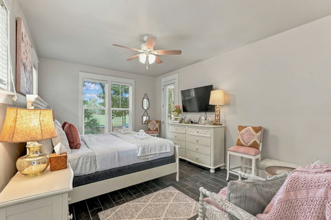 Primary bedroom with dresser and wall-mounted TV