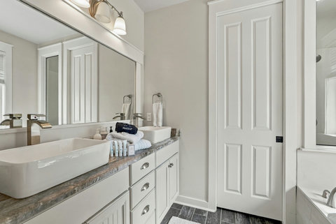 En-suite primary bathroom with double vessel-sink vanity