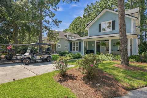 Blue cottage exterior with landscaped front yard