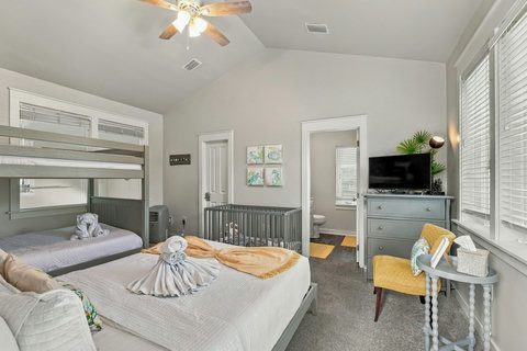 Upstairs en-suite bunk room with queen bed, full-over-full bunks and crib