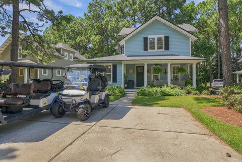 Front of the cottage with covered porch and driveway