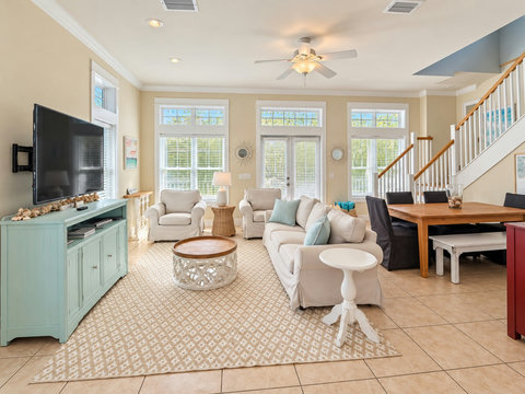 Bright living space with ceiling fan and dining nook