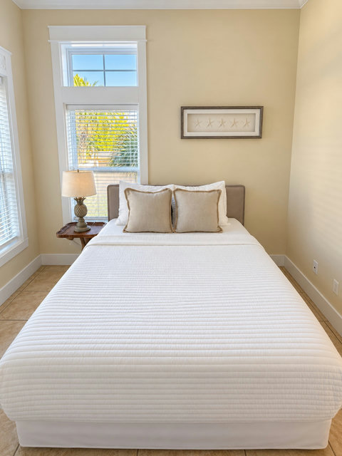 Ground-floor queen bedroom with bright windows
