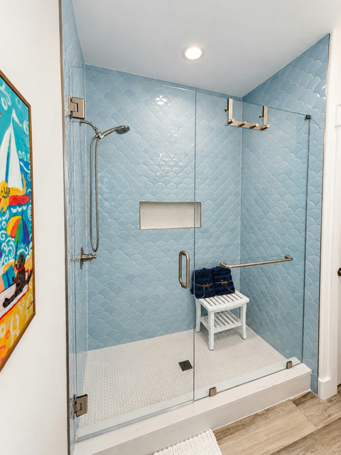 Custom-tiled walk-in shower with bench