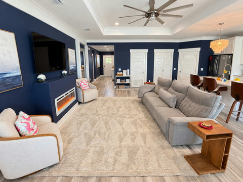 Open great room with sectional, smart TV and electric fireplace