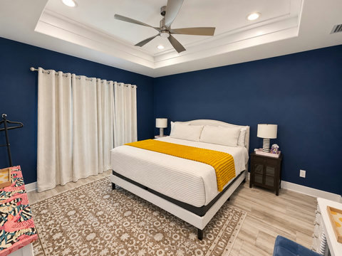 Primary suite: king bed, ceiling fan and blackout curtains