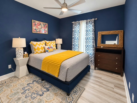 Bedroom 2: queen bed, dresser and ceiling fan