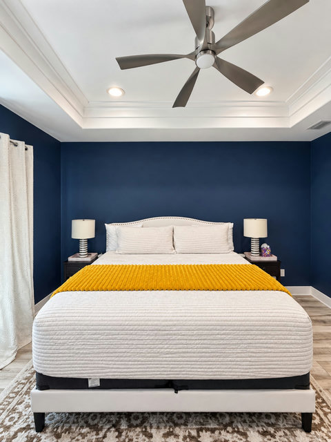 Primary suite with king bed and tray ceiling