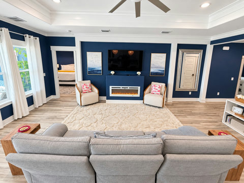 Living room seating facing the TV and electric fireplace