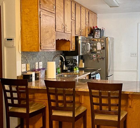 Kitchen breakfast bar with granite countertop and seating for 3