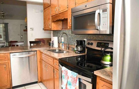 Eat in kitchen with 4 piece updated stainless steel appliances, ice maker, glassware, plates, pots/pans and utensils 