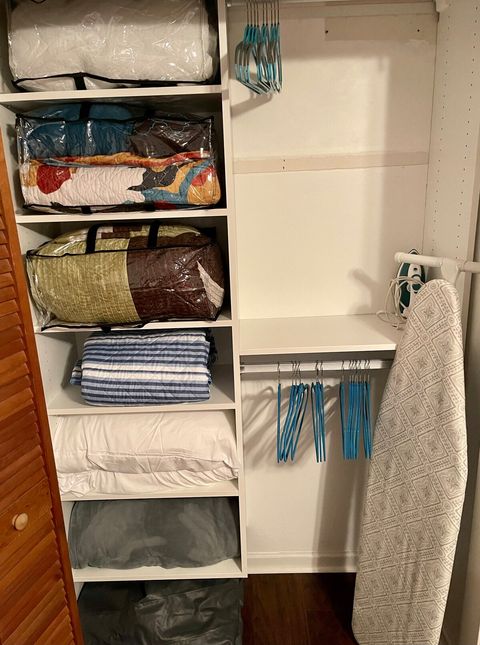 Bedroom closet with queen air mattress, extra pillows, blanket and comforters