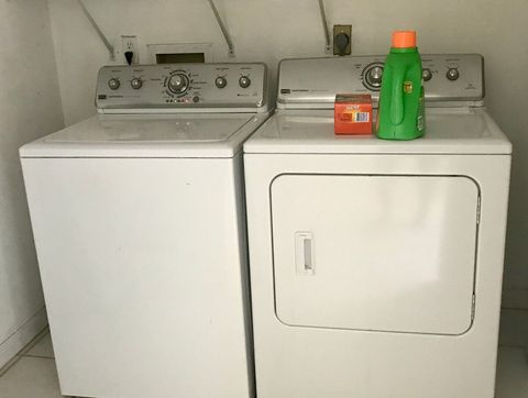 Laundry room with washer, dryer and basic cleaning supplies