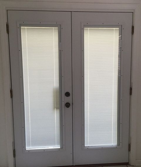 French blinds between the glass doors leading to backyard providing amazing natural light