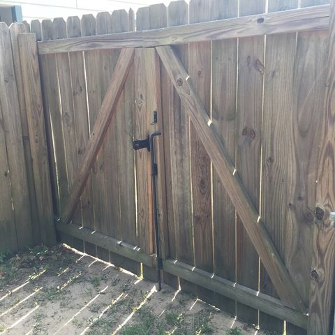 Backyard gate is intentionally secured by a padlock. You will only be able to get to the backyard from inside the house.  The city garbage can next to the shed is solely used for yard debris.  There is a can to the left of porch for household waste.