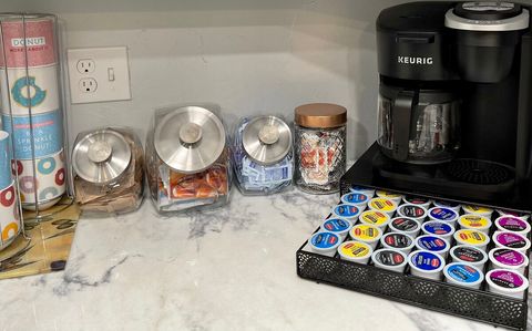 Coffee bar stocked with coffee, tea, apple cider, hot chocolate, sugar, equal, creamer and disposable stirrers