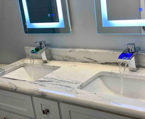 Faucet color changes with the water temperature.  Hair dryer, body wash, shampoo and conditioner under sink (right side)