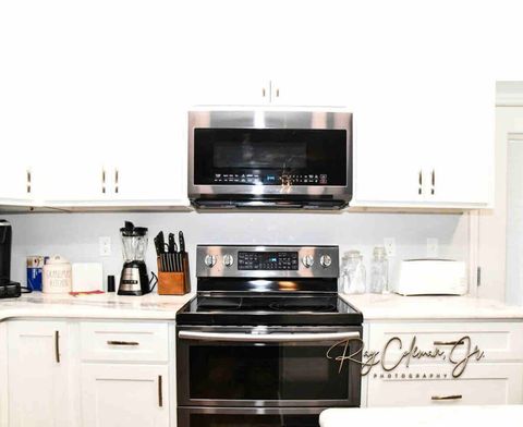 Kitchen contains toaster, pots, pans, dishes, utensils and food storage containers 