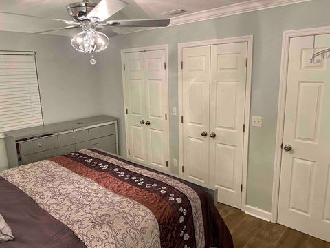 Master bedroom with ample closet space - iron & ironing board in closet