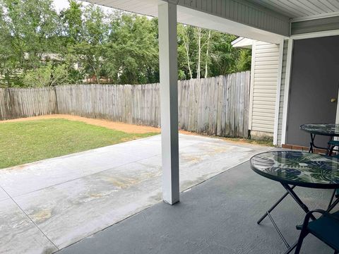 Fenced in backyard with covered and uncovered patio 