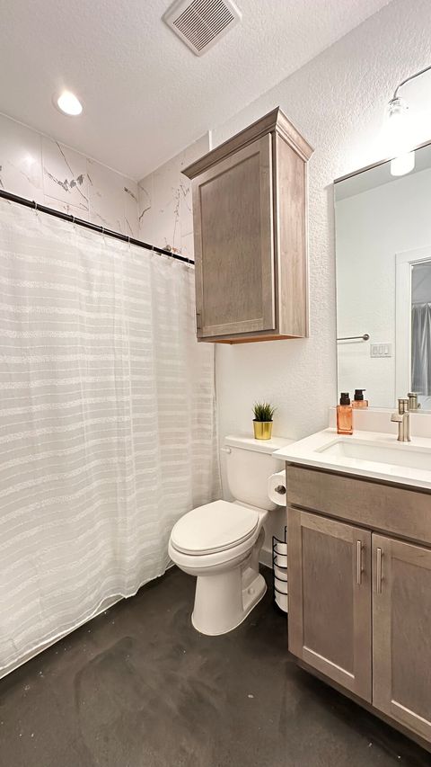 Full bathroom features dimmable vanity lights, shower light, magnetic handheld shower head, bathtub, crisp, clean towels and bath mats, hand soap and a hair dryer.  Shower dispensers include body wash, shampoo, and conditioner. 
