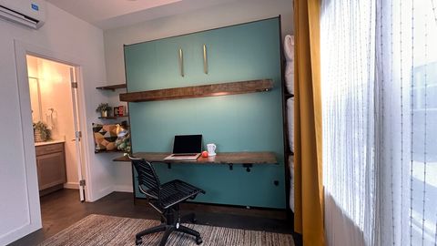 Shelves to the right of the fold-down desk are perfect for stashing the pillows to close the wall-bed.  Shelves to the left house books, a touch light, a Google nest mini, still leaving space for your bedside needs.
