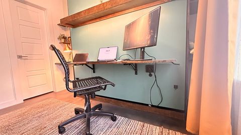 There is just enough space behind the desk surface to allow cords to be tucked away where they can be plugged into the surge protector under the fold-down desk.  (computer/monitor not provided)