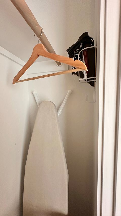 The downstairs bedroom closet houses the ironing board and iron.