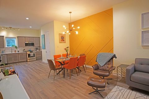 Dining table has seating for 6.  Extra seating and a folding table are stored between the sofa and wall for larger groups.  Place settings for 10, plus children’s dishes.