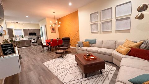 Second floor features a great open space where the kitchen flows into the dining room which flows into the living room.  Full kitchen, half bath, bar cart, and cabinet space for guest groceries. Extra blankets can be found in the ottoman.