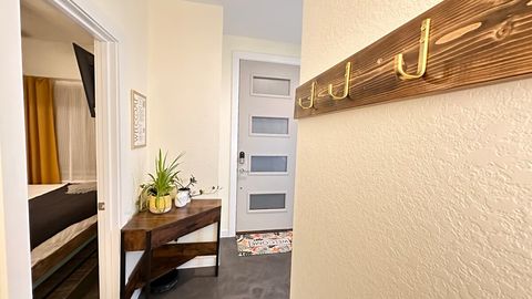 The view as you enter from the door to the garage.  Plenty of hooks for all your grab-on-the-way-out-the-door items, a drop zone desk, entrance to the first floor bedroom/office, and the front door with keyless entry.