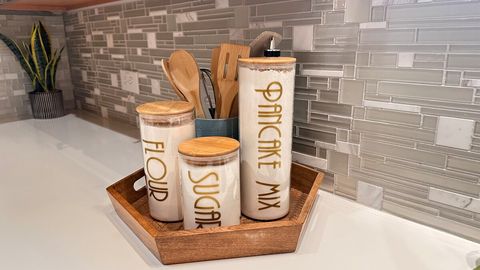 The basics for cooking:  baking mix, flour, sugar, olive oil, salt, pepper, a few spices.  Some displayed, some neatly tucked away in the cabinet to keep the surfaces clear and clutter-free.