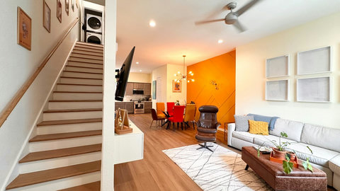 Kitchen, dining room, and living room in an open floor plan on the second story. Laundry at the top of the stairs on the 3rd floor.