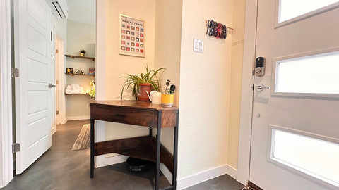 The entryway includes a drop zone with a drawer full of umbrellas, a place to hang sunglasses and a row of sturdy hooks on the wall for your coats, bags, etc.  