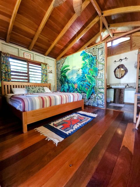 Bedroom features a King bed and hand-painted mural by local artists.