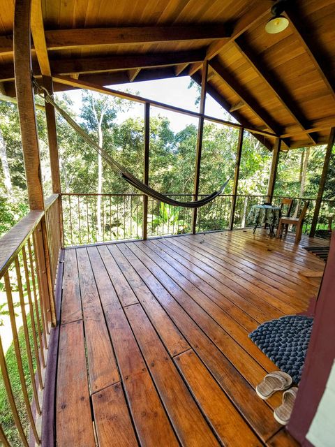 Spacious deck, with seating for two, plus dining table and hammock