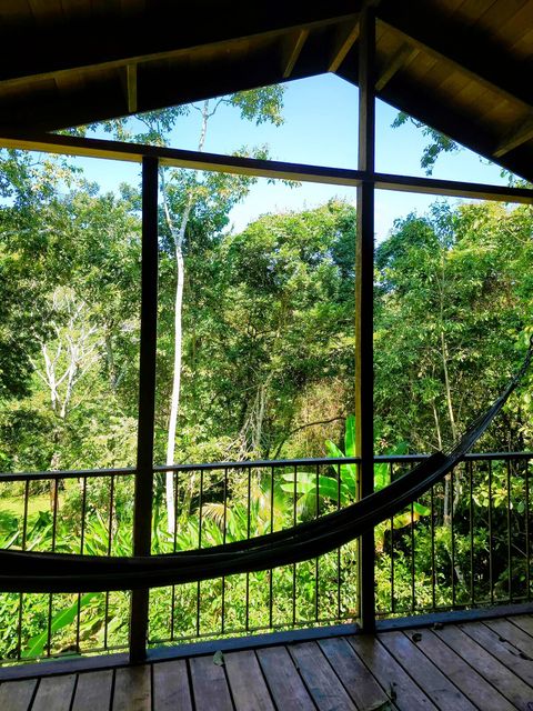 Spacious deck, with seating for two, plus dining table and hammock