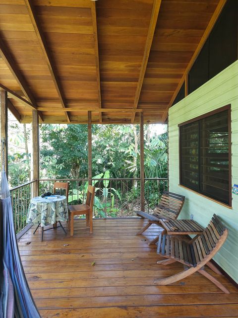 Spacious deck, with seating for two, plus dining table and hammock