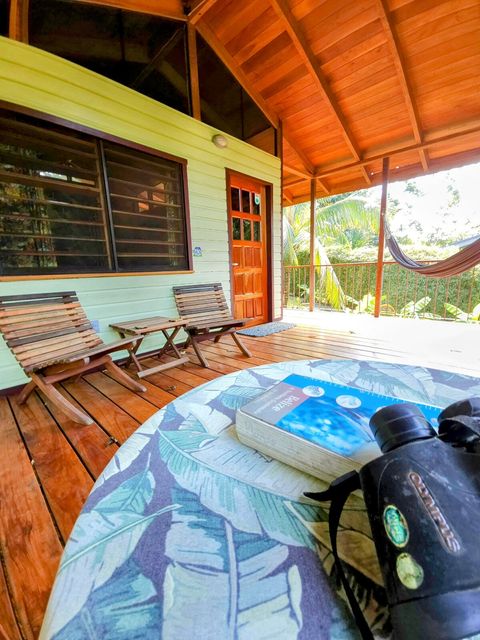 Spacious deck, with seating for two, plus dining table and hammock