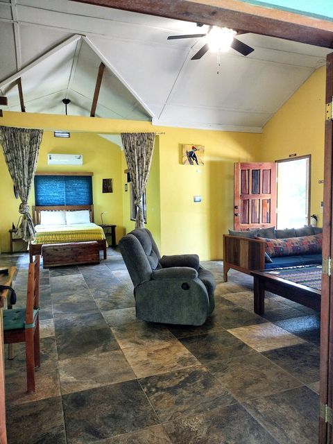 Living room with view of bedroom.  Privacy curtains separate bedroom from living room if needed.