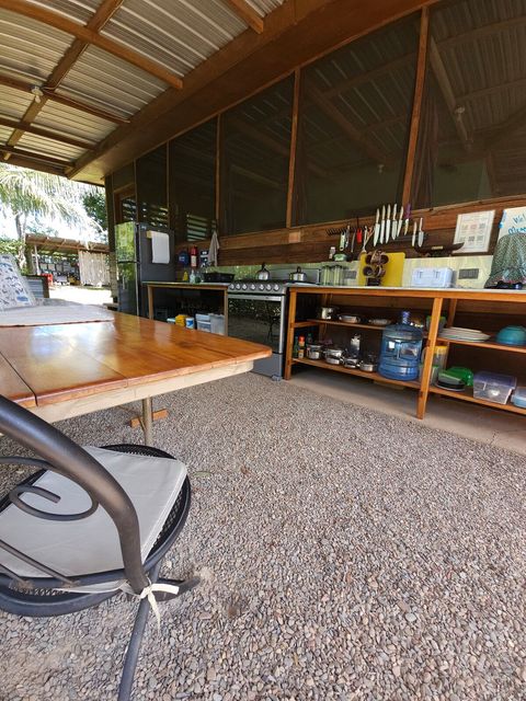 Shared outdoor kitchen - includes 6 burner stovetop, full-size frig/freezer and double sink with plenty of counter space and a charcoal grill!