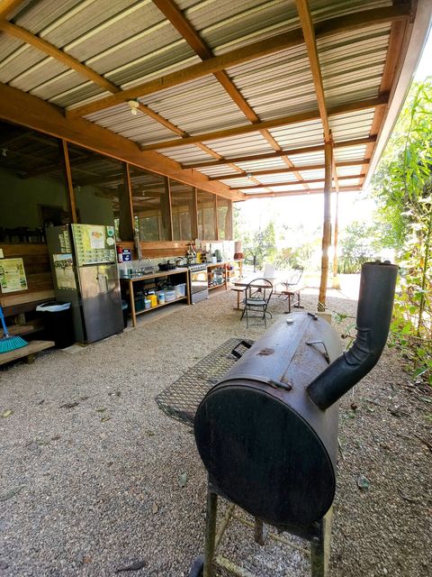 Shared outdoor kitchen - includes 6 burner stovetop, full-size frig/freezer and double sink with plenty of counter space and a charcoal grill!